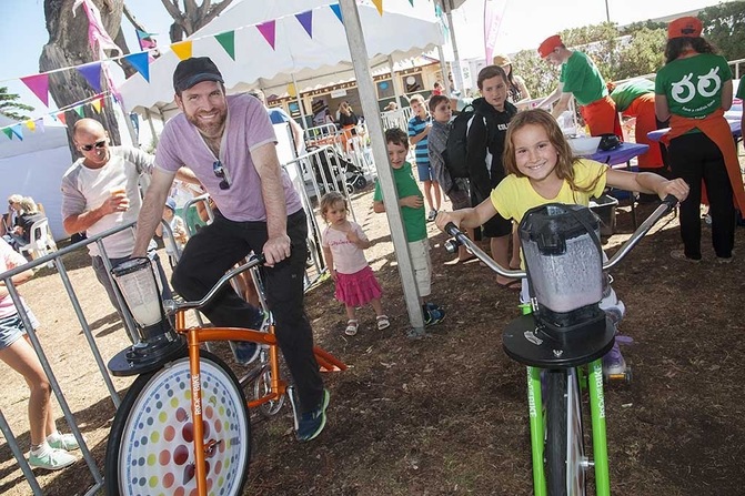 Child and adult on smoothie bikes
